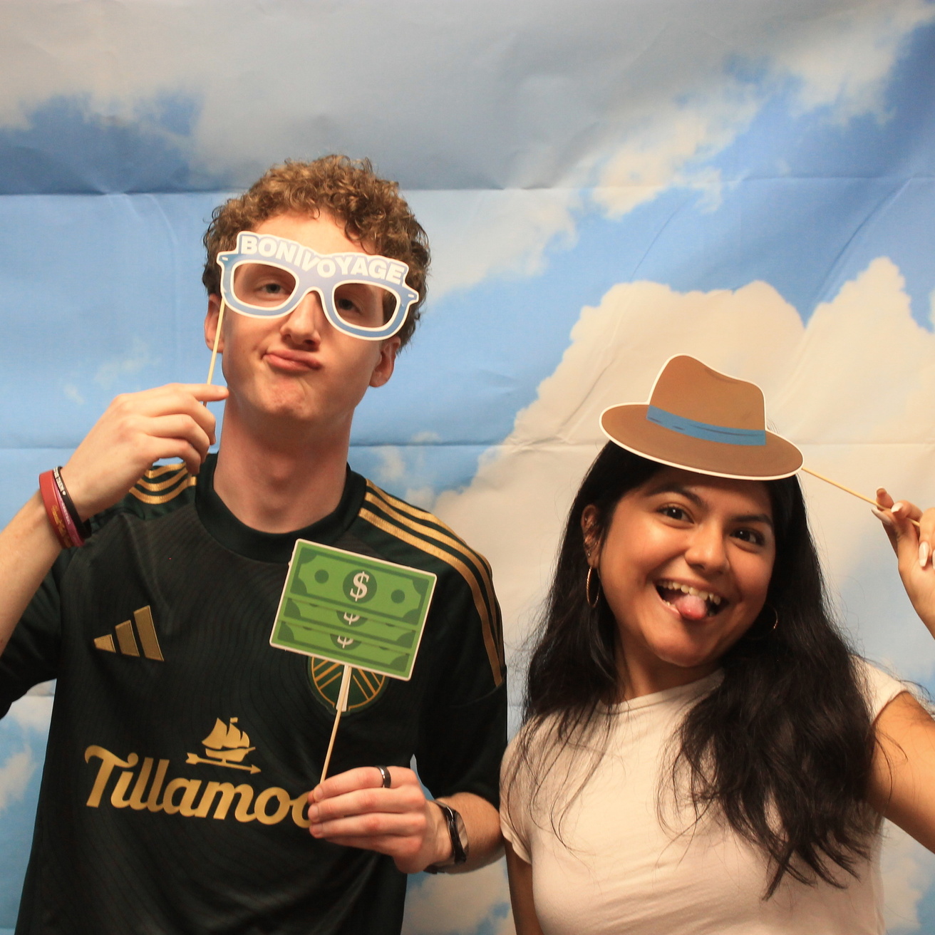 high school student poses with UI Spanish tutor at the photobooth exhibit for World Language Day