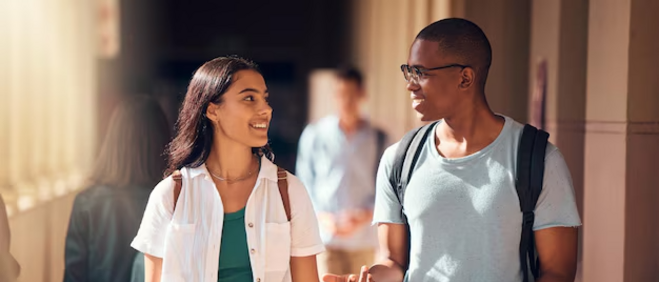 two students walking towards the camera having a conversation
