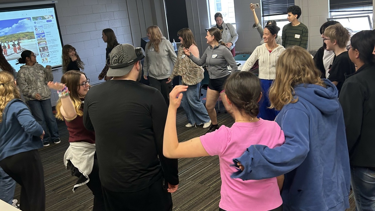 high school students dancing during a session with Chinese faculty about traditional Tibetan dance