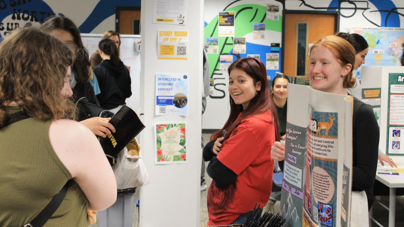 high school students discussing language at World Language Day tables